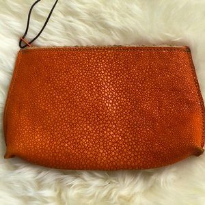 Orange leather textured zip purse.